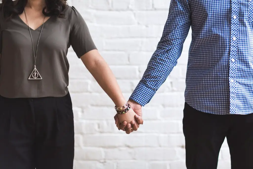 Girlfriend and boyfriend holding hands and figuring out how to move forward