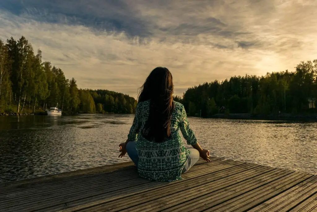 This image shows a woman meditating and enjoying her life of solitude and independence. This image was used in the article, My Girlfriend Doesn't Want To Get Married (10 Reasons Why) 