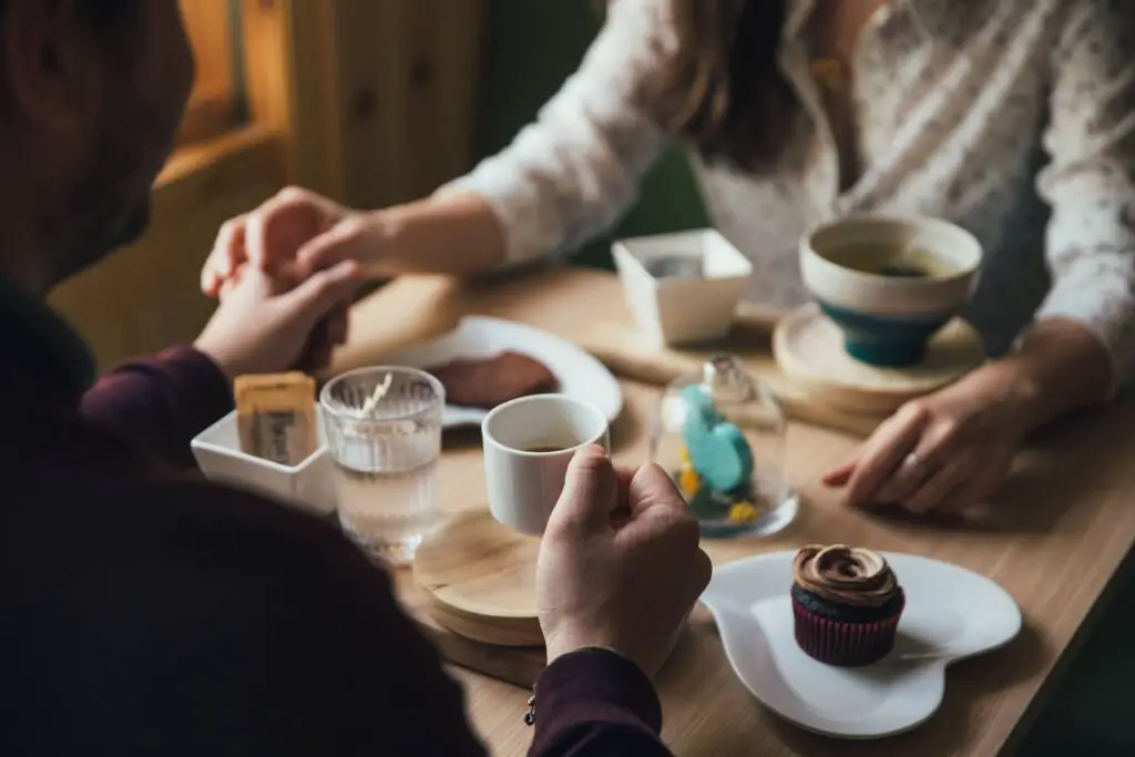 This image shows a boyfriend holding hands with his girlfriend on a date. It's used for the article, "girlfriend gaining weight" 