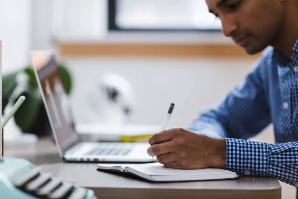 This image shows a man self-reflecting and journaling her thoughts. It's used for the article, 12 Reasons Why My Girlfriend Keeps Talking About Her Ex