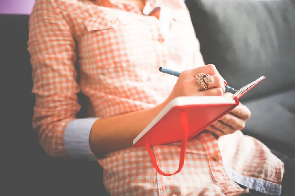 This image shows a woman journalling. It's used in the article, "My boyfriend hasn't called in a week"