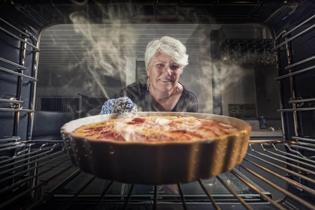 This image shows a woman cooking. It's used for the article, How to make my boyfriend feel special on his birthday 