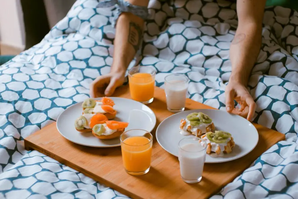 This image shows breakfast in bed. It's used for the article, How to make my boyfriend feel special on his birthday