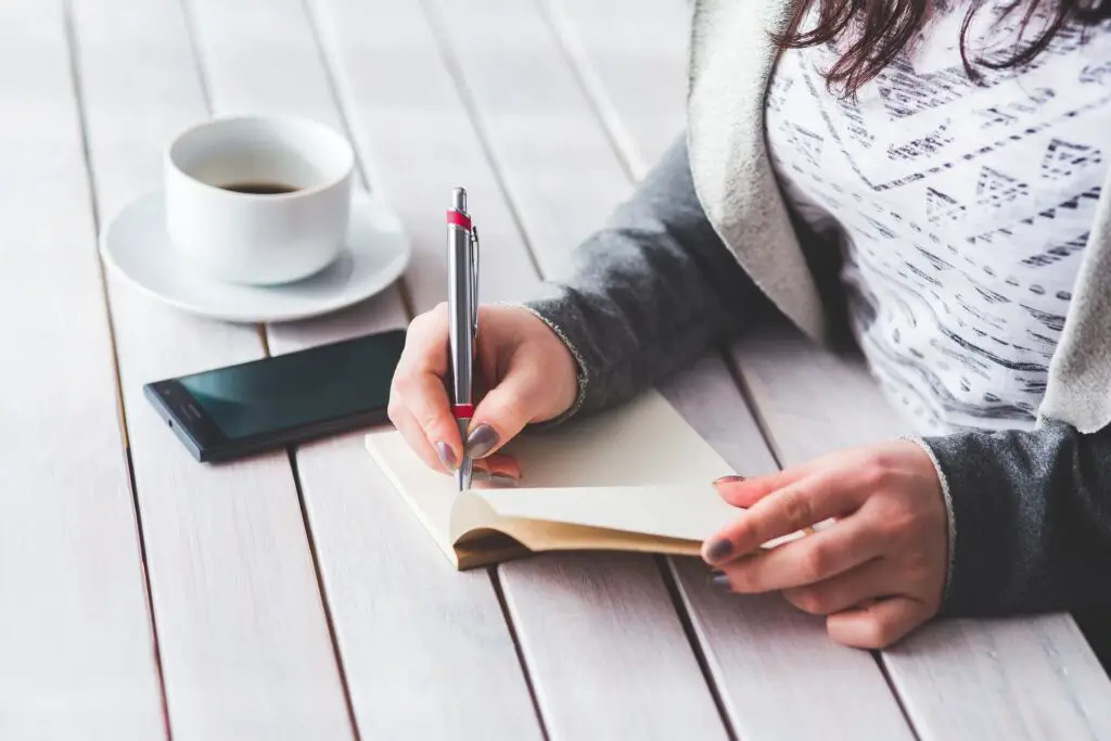 This image shows a woman journaling. It's used for the article "My boyfriend makes no effort on my birthday"