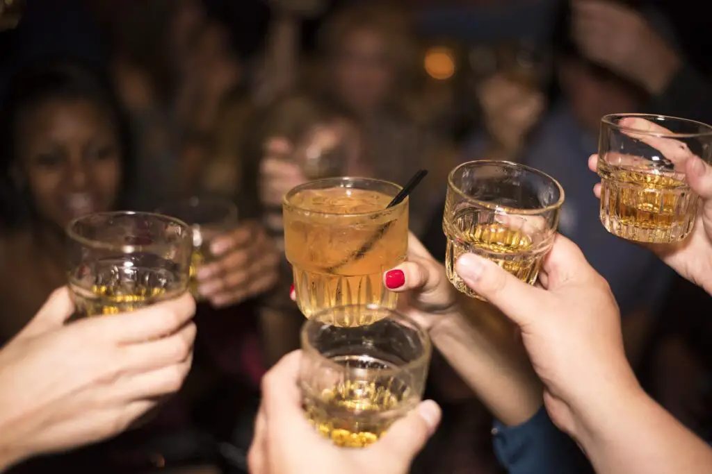 This shows a group of friends making a toast. It's used for the article, Why is my boyfriend a different person when he's drunk?