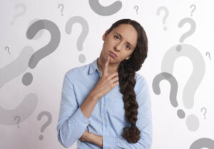 This image shows a woman thinking. It's used for the article "how to stop overthinking in a long-distance relationship"