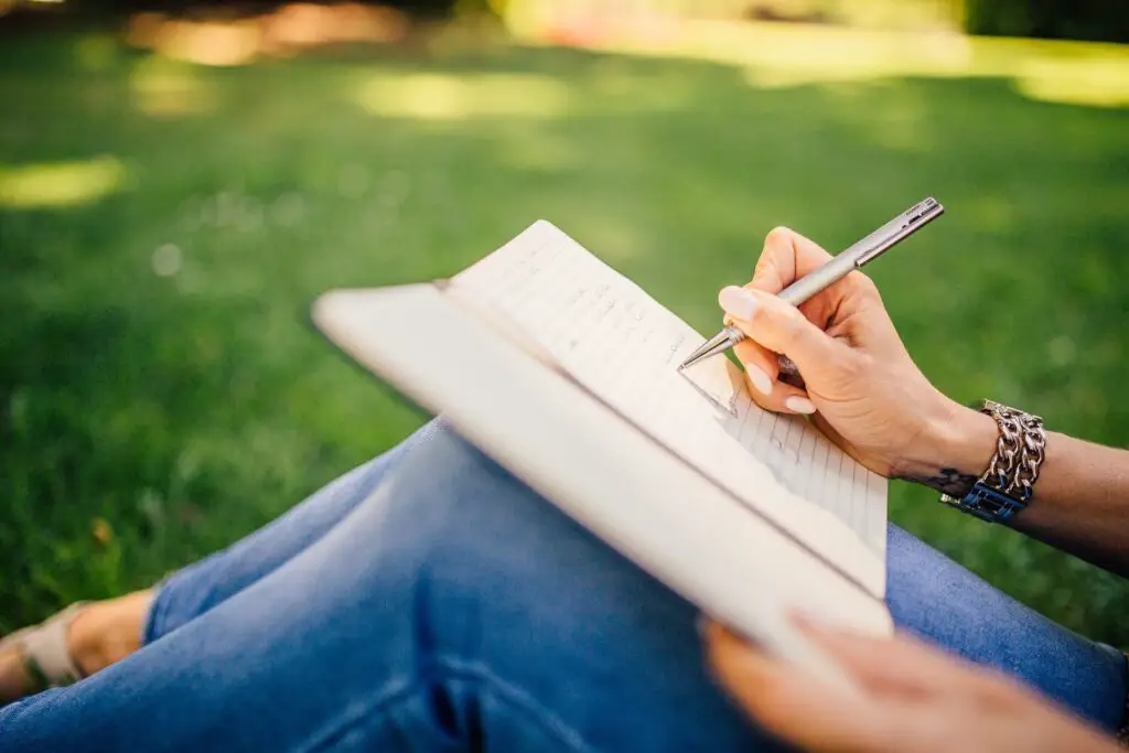 This image shows someone journaling their thoughts. It's used in the article "how to stop overthinking in a long-distance relationship"