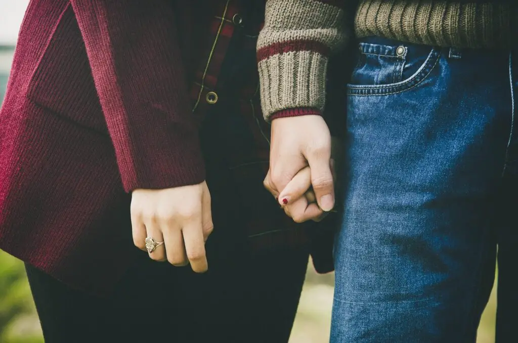 This image shows a couple holding hands. It's used in the article "long distance relationship conversation topics" 