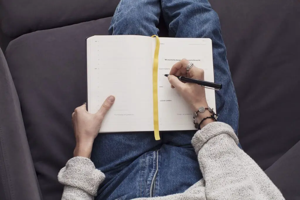 This image shows someone journaling. It's used in the article "How to date with intention"