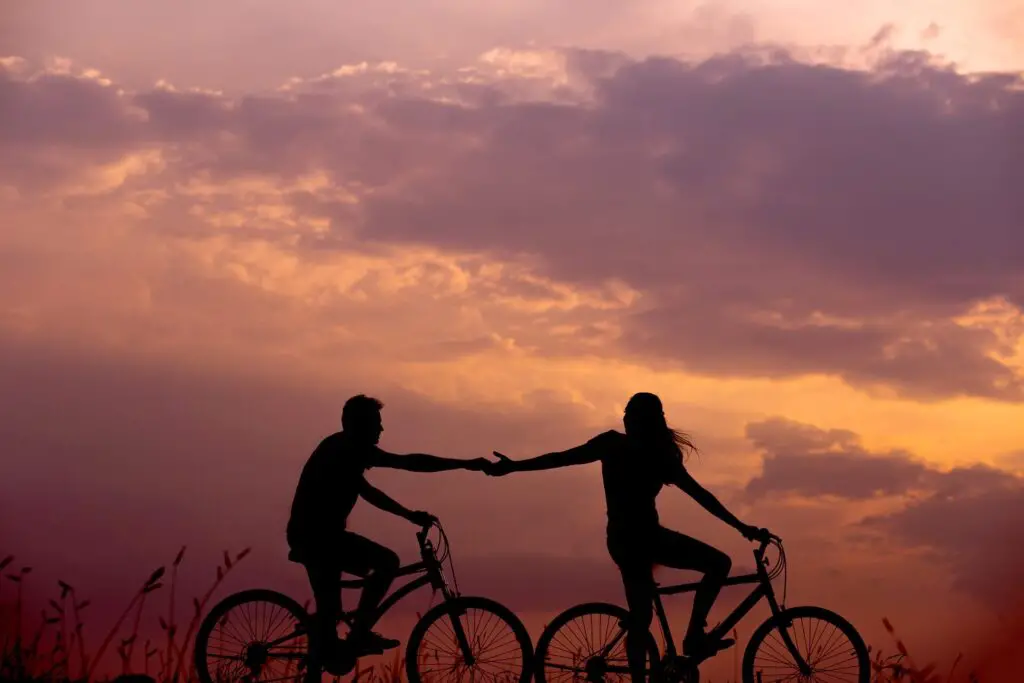 This image shows a couple cycling. It's used for the article "questions to ask on date" 