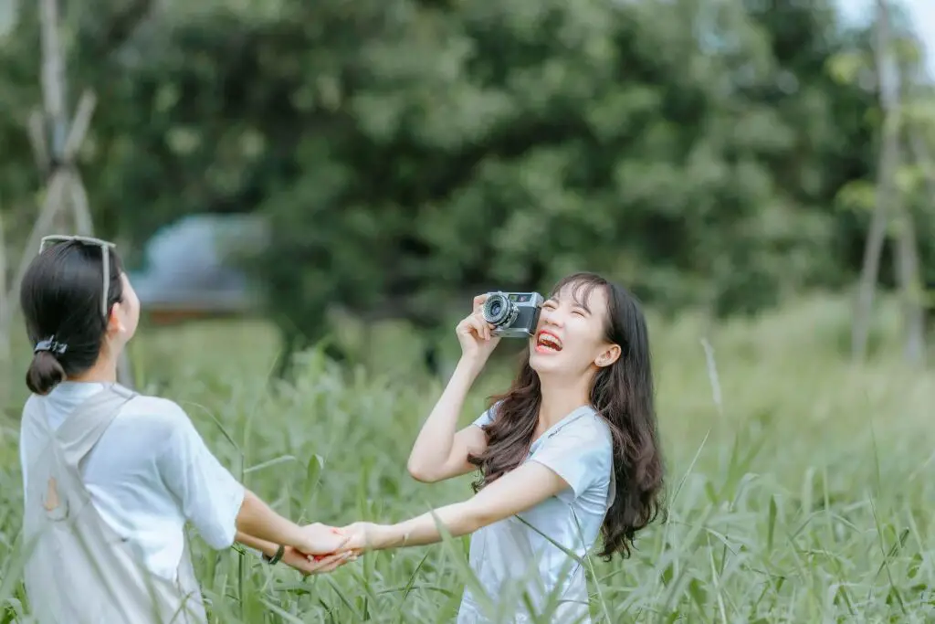 This image shows two friends laughing.  It's used for the article "should I block someone who ghosted me?" 